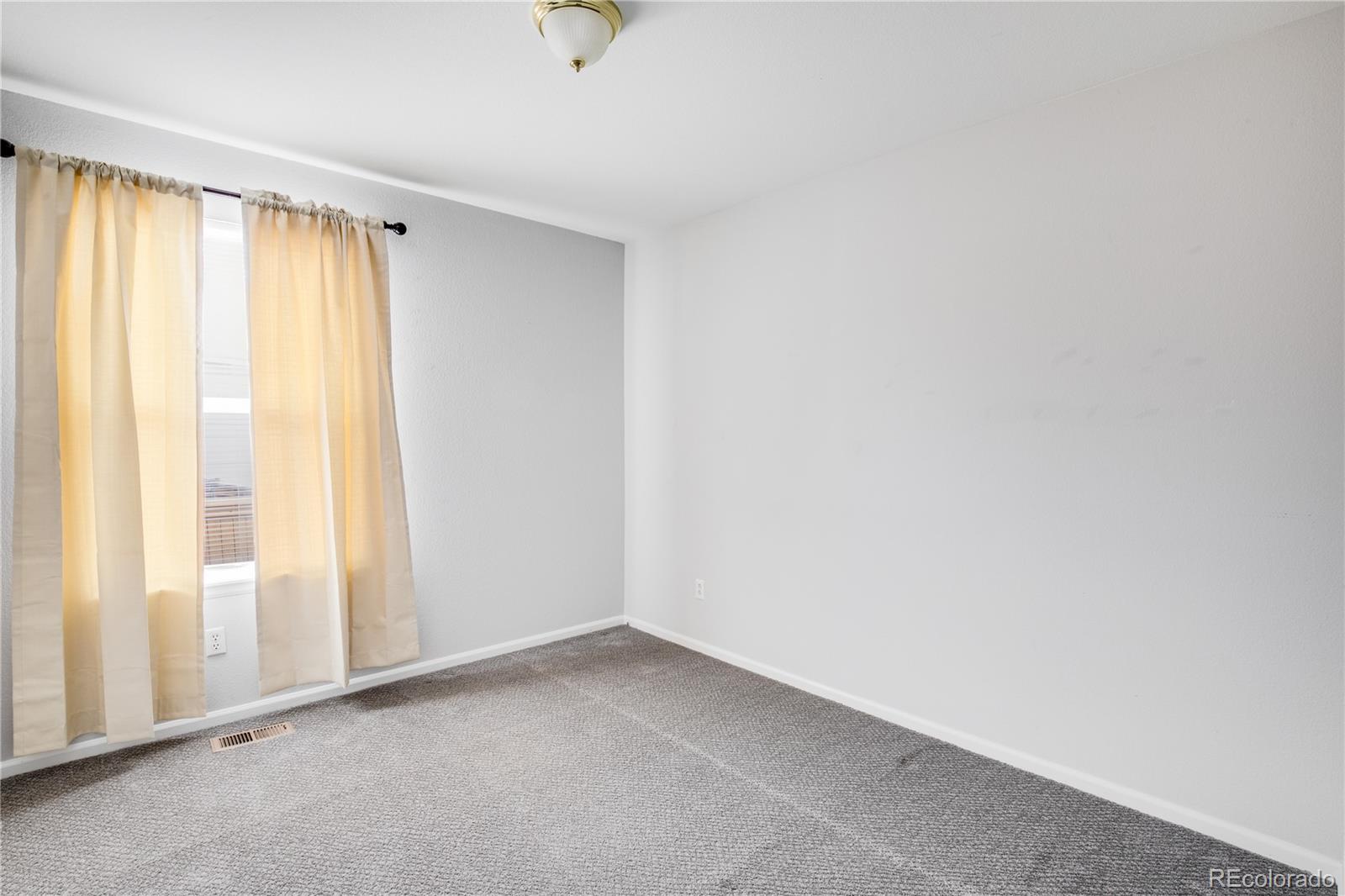 7135 Leopard Drive Lone Tree, CO 80124 - Photo 12 of 47 a view of an empty room with a window