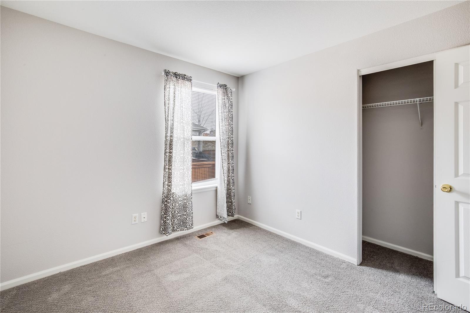 7135 Leopard Drive Lone Tree, CO 80124 - Photo 14 of 47 an empty room with windows