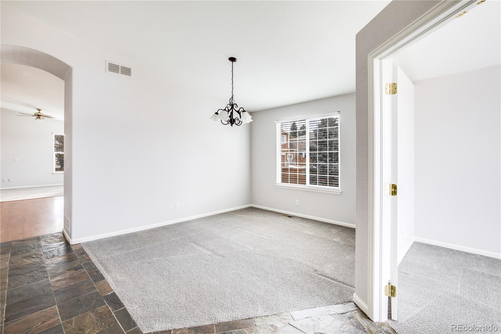 7135 Leopard Drive Lone Tree, CO 80124 - Photo 17 of 47 a view of an empty room with wooden floor and a window