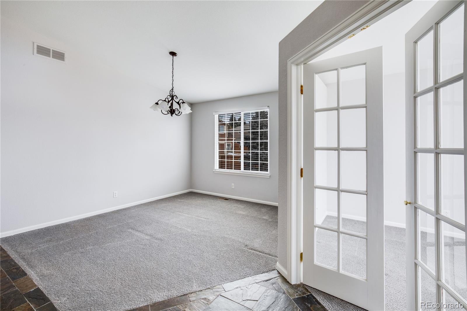 7135 Leopard Drive Lone Tree, CO 80124 - Photo 18 of 47 an empty room with windows