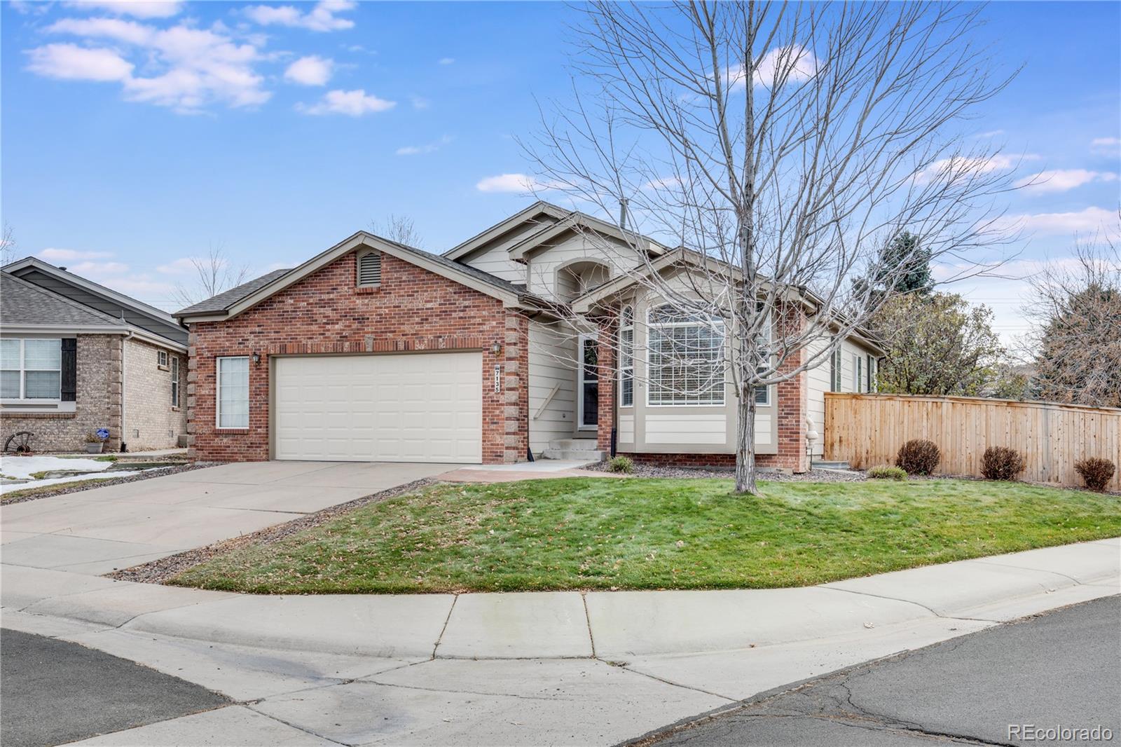 7135 Leopard Drive Lone Tree, CO 80124 - Photo 2 of 47 a front view of a house with a yard and garage