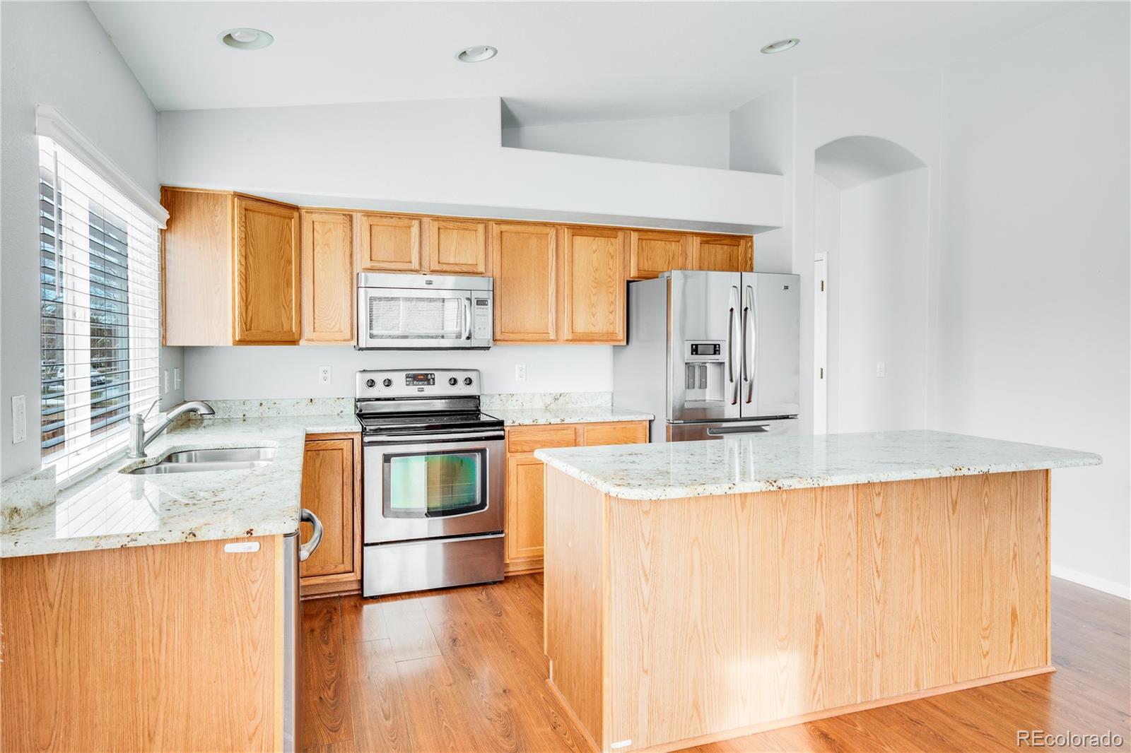 7135 Leopard Drive Lone Tree, CO 80124 - Photo 29 of 47 a kitchen with granite countertop a sink and a stove top oven