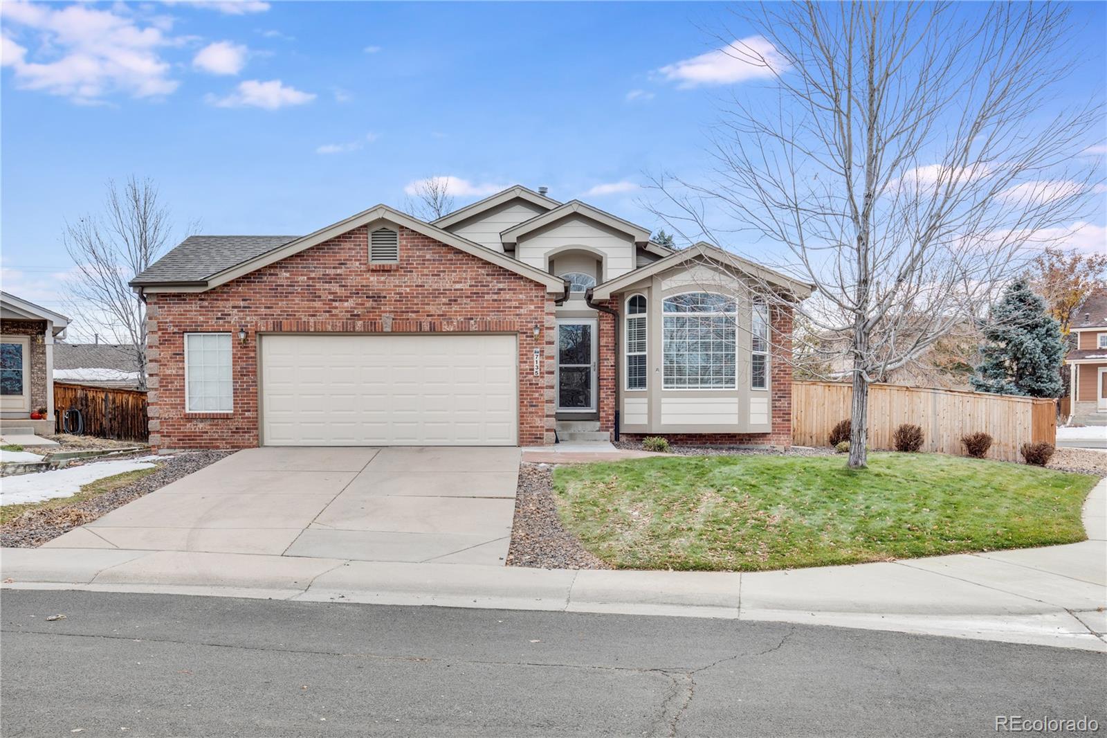 7135 Leopard Drive Lone Tree, CO 80124 - Photo 3 of 47 a front view of a house with a garden and trees