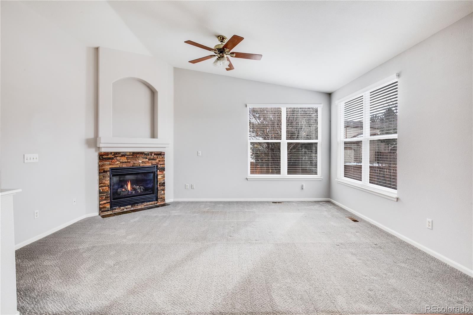 7135 Leopard Drive Lone Tree, CO 80124 - Photo 31 of 47 an empty room with furniture and a fireplace
