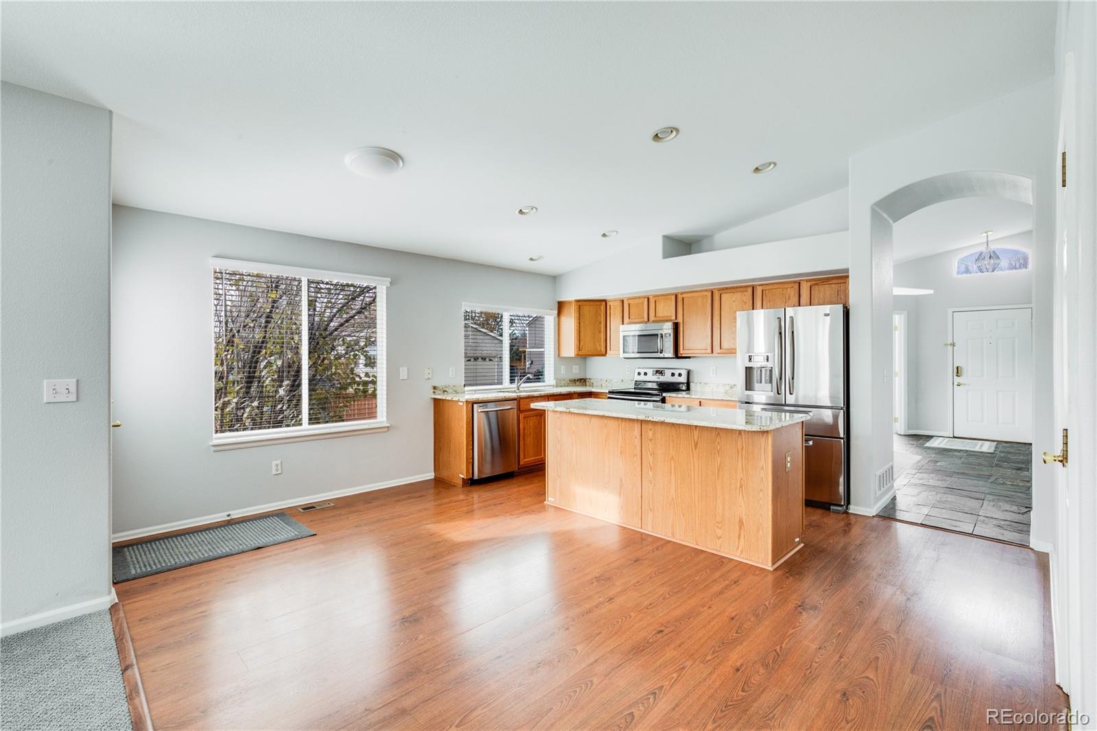 7135 Leopard Drive Lone Tree, CO 80124 - Photo 32 of 47 a large open kitchen with a refrigerator and a stove top oven