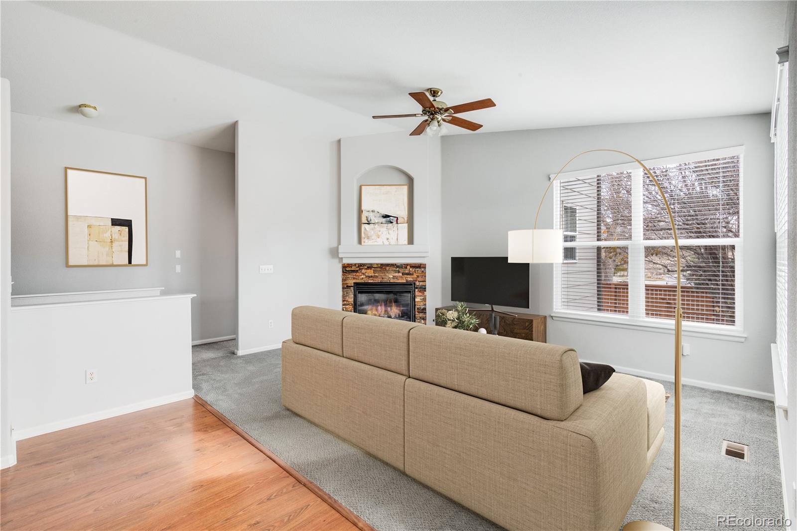 7135 Leopard Drive Lone Tree, CO 80124 - Photo 33 of 47 a living room with furniture and a large window