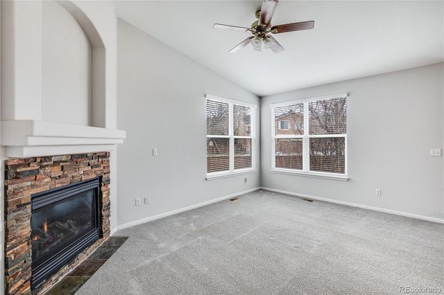a view of an empty room with a fireplace