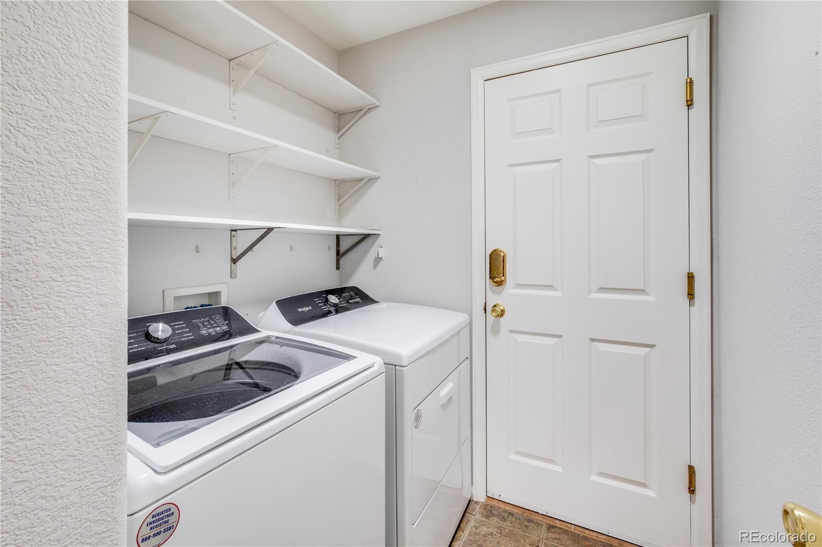 7135 Leopard Drive Lone Tree, CO 80124 - Photo 37 of 47 a utility room with dryer and washer