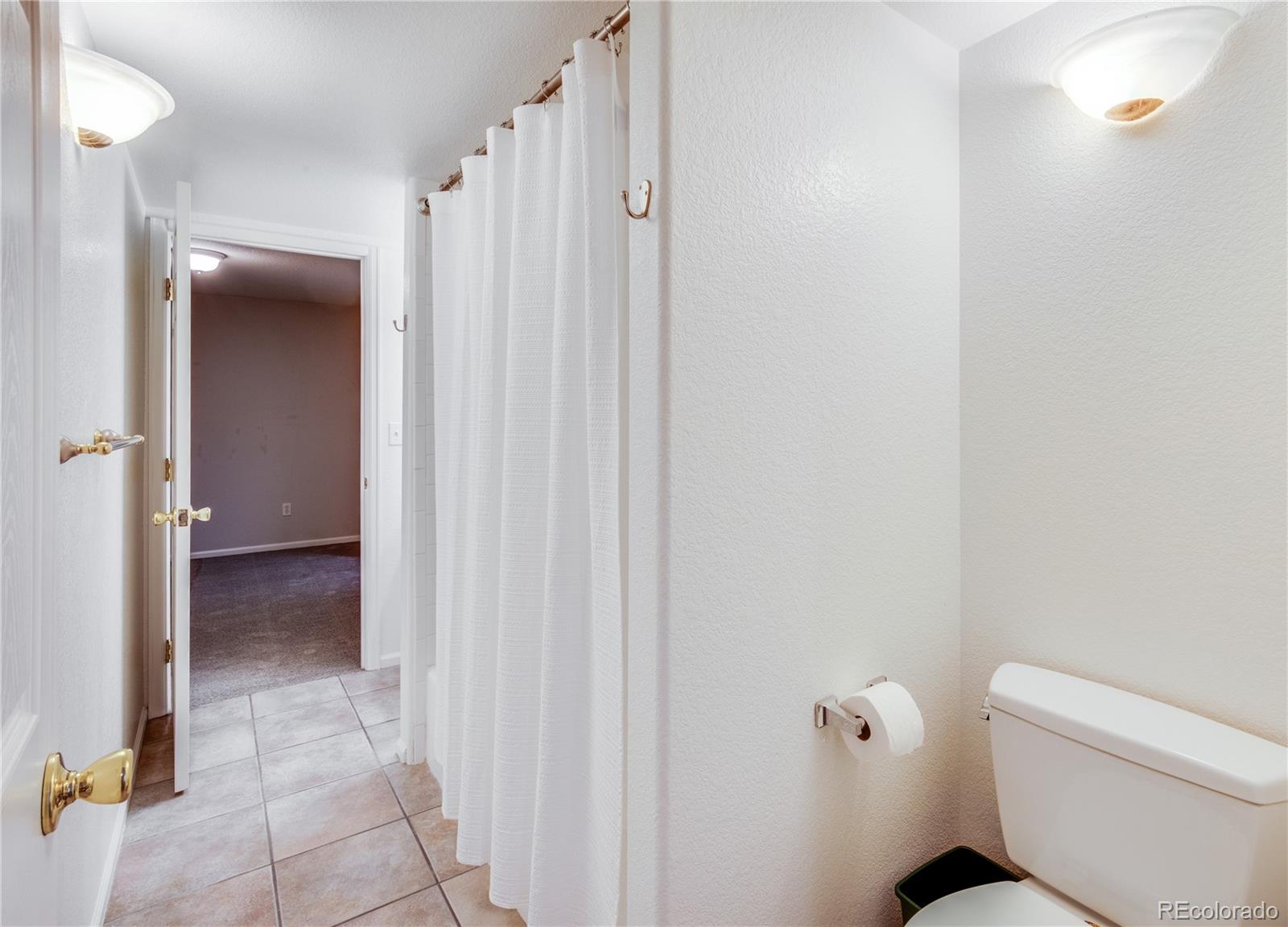 7135 Leopard Drive Lone Tree, CO 80124 - Photo 43 of 47 a bathroom with a toilet and a shower