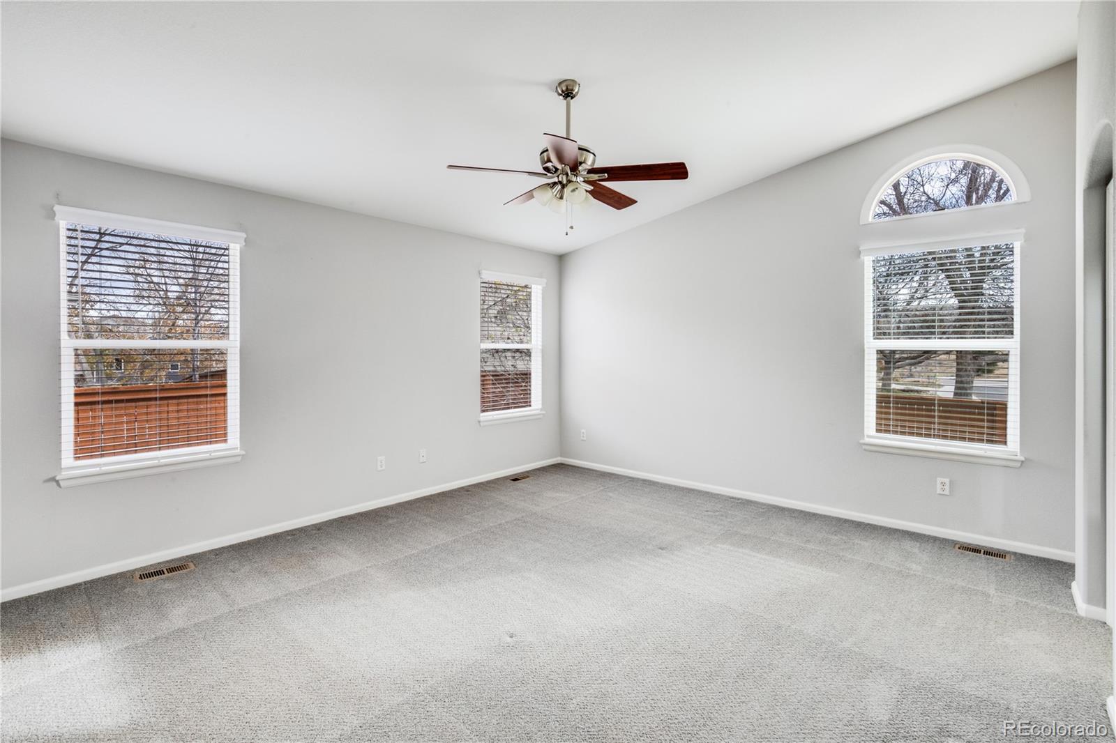 7135 Leopard Drive Lone Tree, CO 80124 - Photo 6 of 47 an empty room with windows and fan
