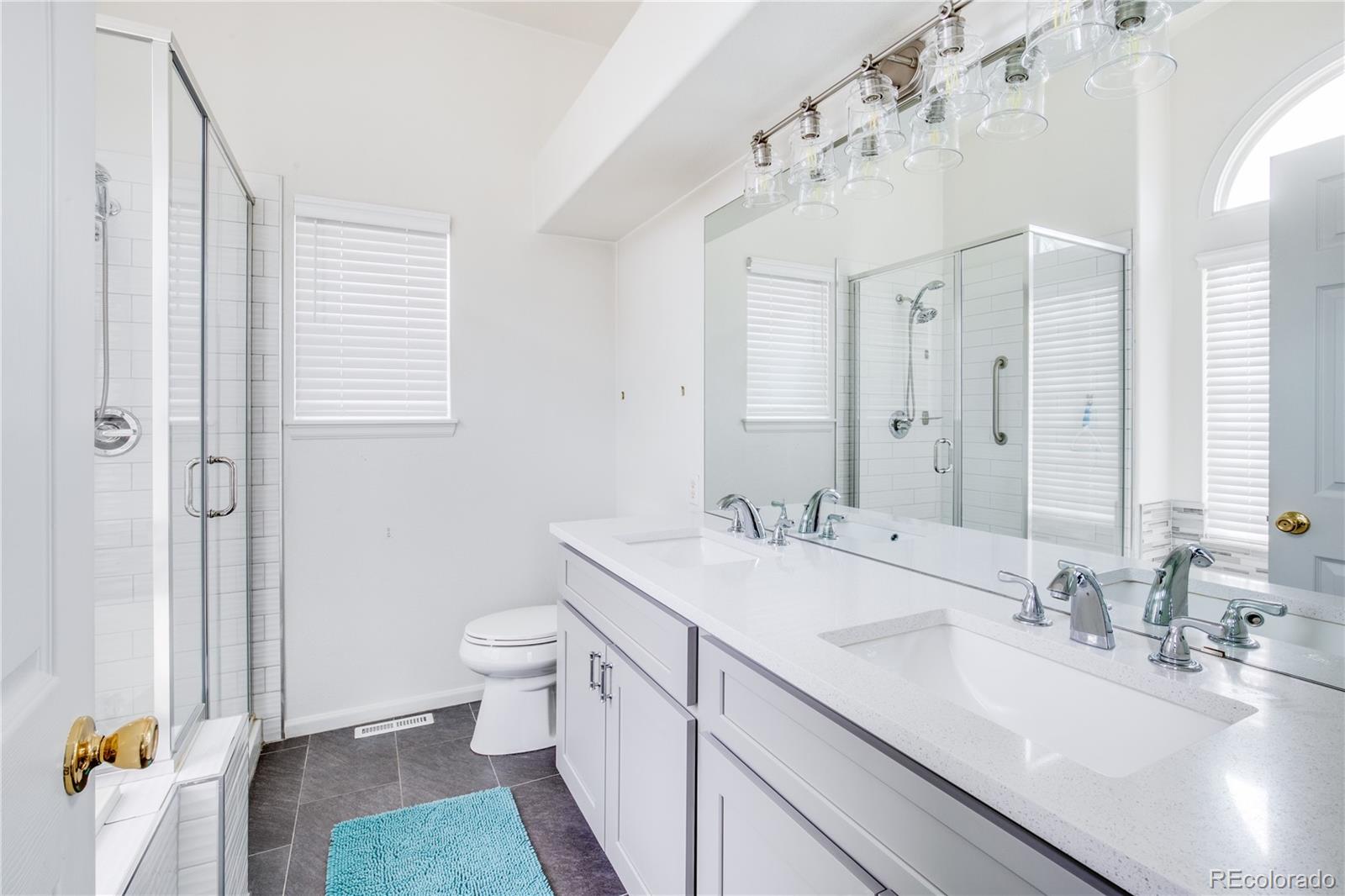 7135 Leopard Drive Lone Tree, CO 80124 - Photo 9 of 47 a bathroom with a sink double vanity and a toilet
