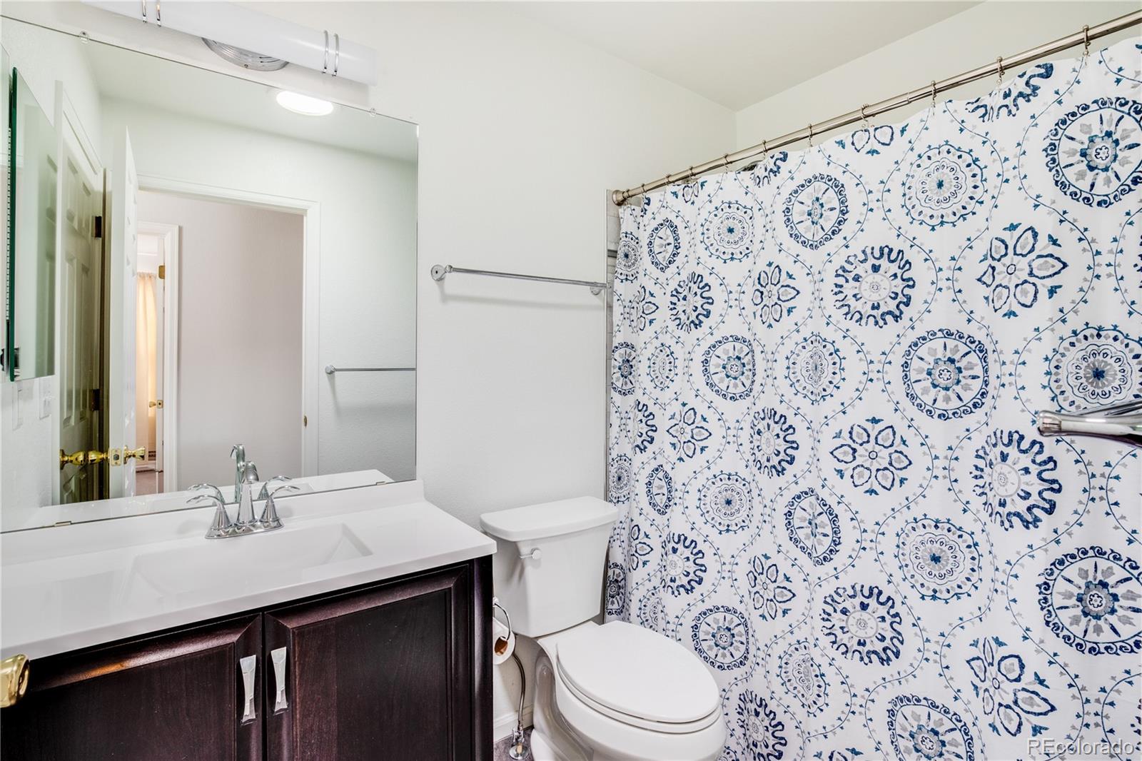 7135 Leopard Drive Lone Tree, CO 80124 - Photo 10 of 47 a bathroom with a sink toilet and shower