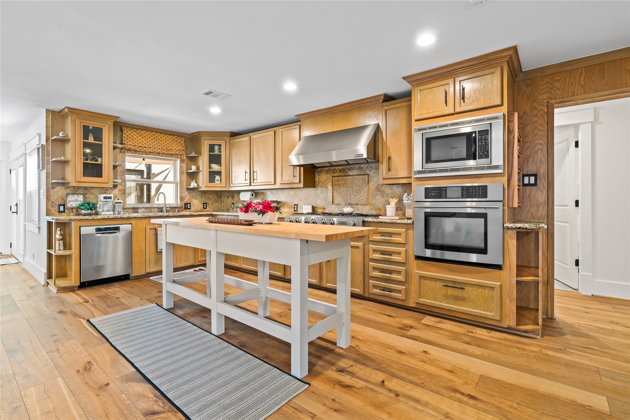 a kitchen with stainless steel appliances a stove top oven and a refrigerator