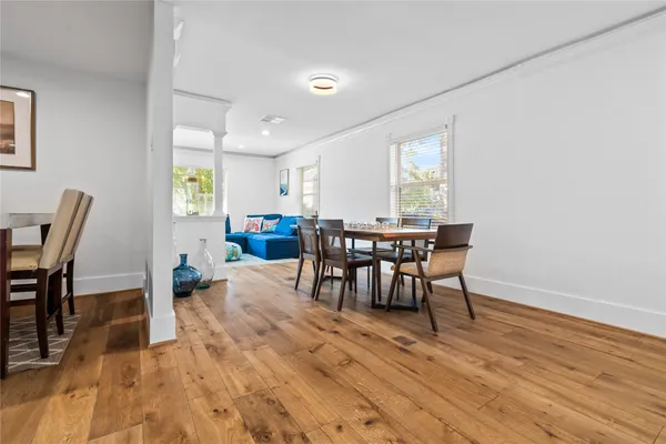a view of a dining room with furniture and wooden floor