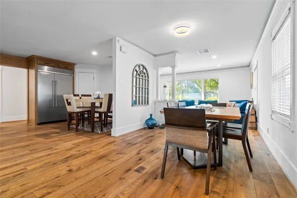 a view of a dining room with furniture and wooden floor