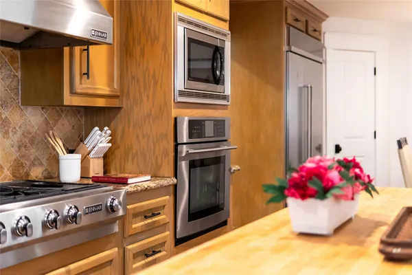 a kitchen with stainless steel appliances granite countertop a stove and a refrigerator