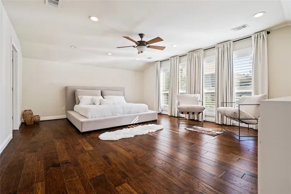 a bedroom with furniture and a large window