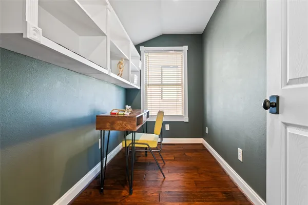 a view of a room with furniture and wooden floor
