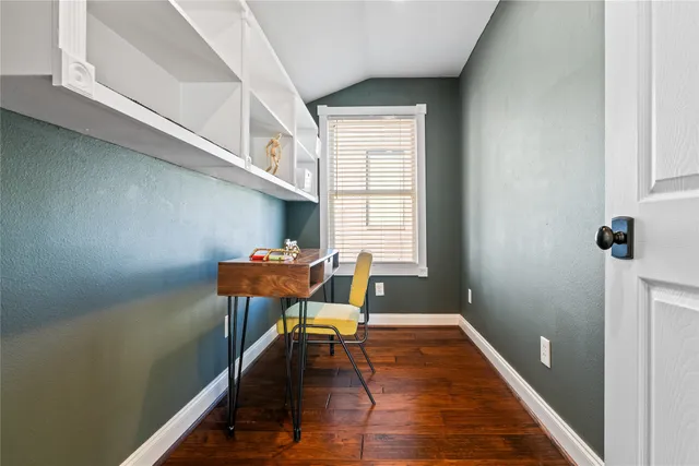 a view of a room with furniture and wooden floor