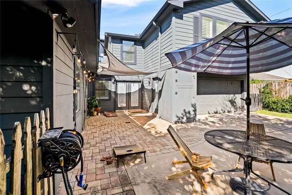 a view of a patio with table and chairs and potted plants