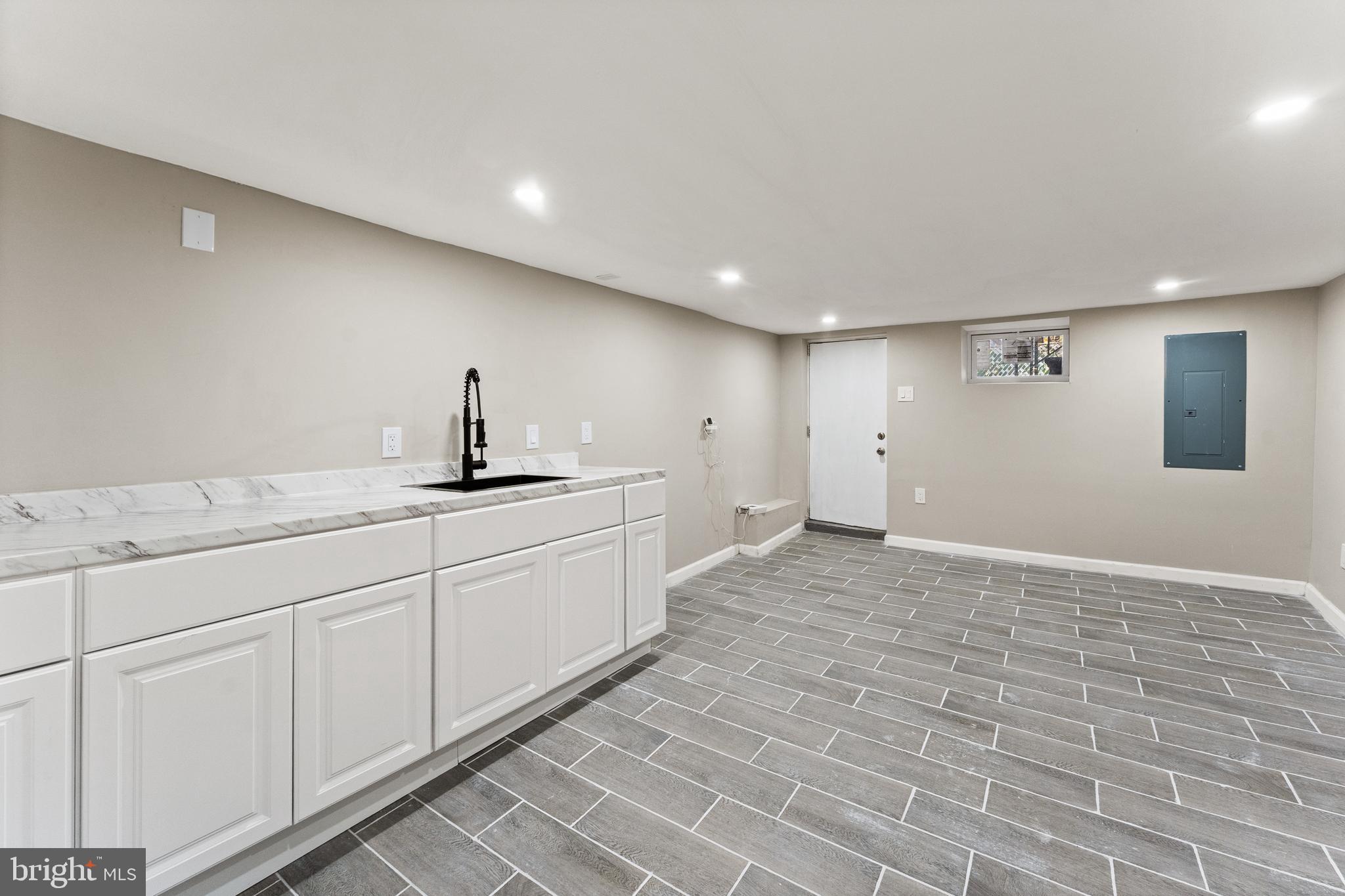 602 Denison Street Baltimore, MD 21229 - Photo 11 of 17 a bathroom with a sink a vanity and a mirror