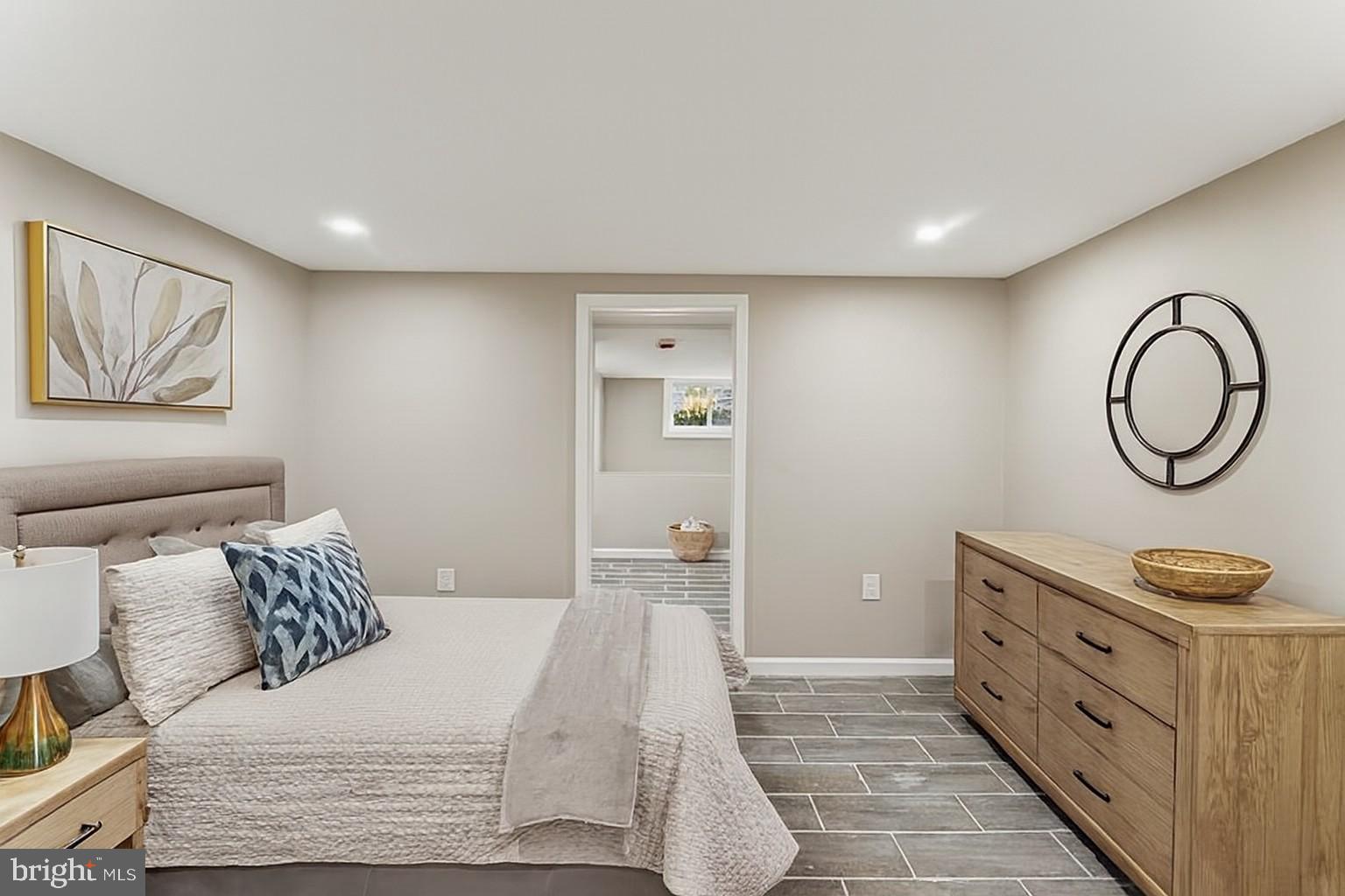 602 Denison Street Baltimore, MD 21229 - Photo 16 of 17 a bedroom with a bed and a painting on the wall