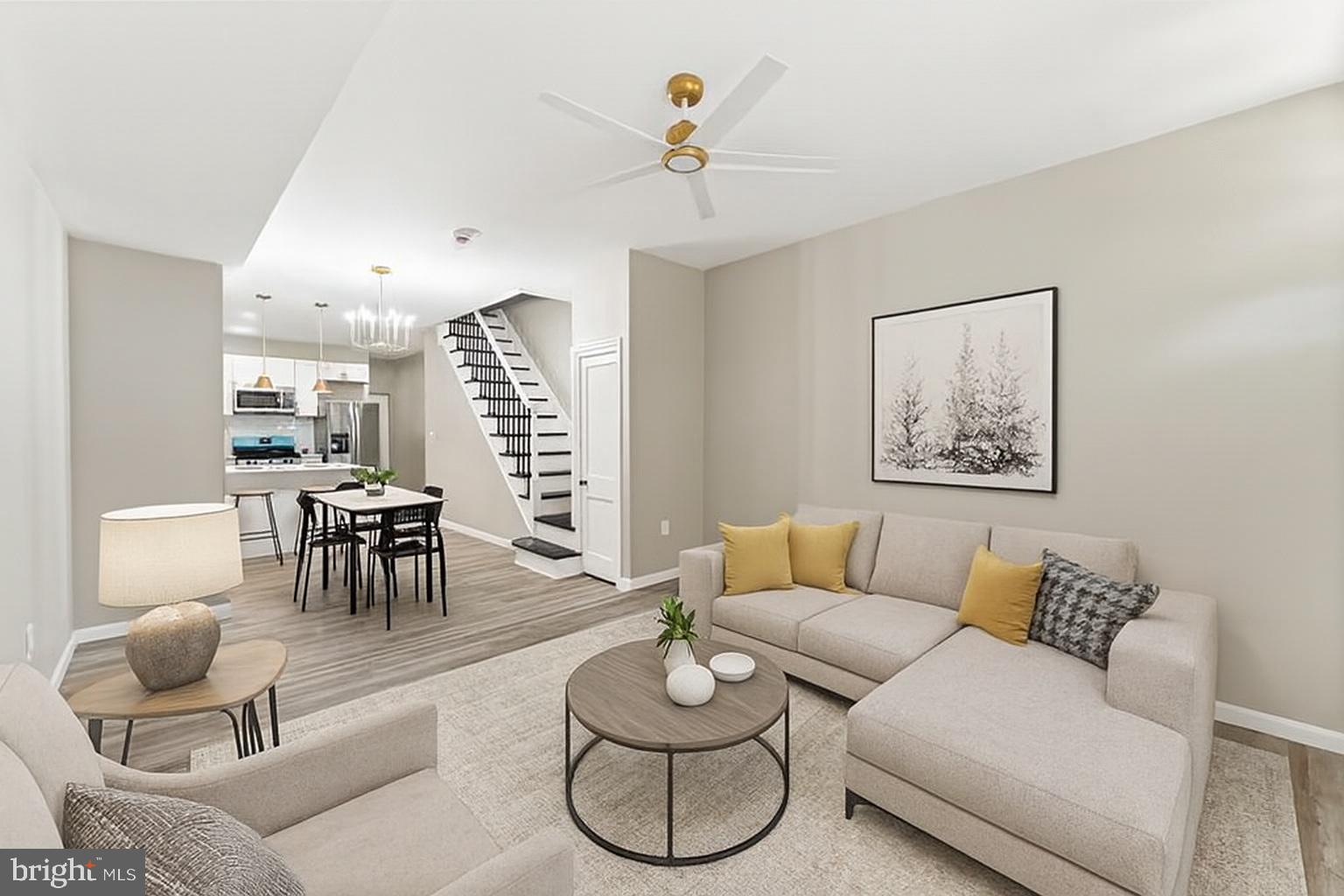 602 Denison Street Baltimore, MD 21229 - Photo 2 of 17 a living room with furniture potted plant and white walls