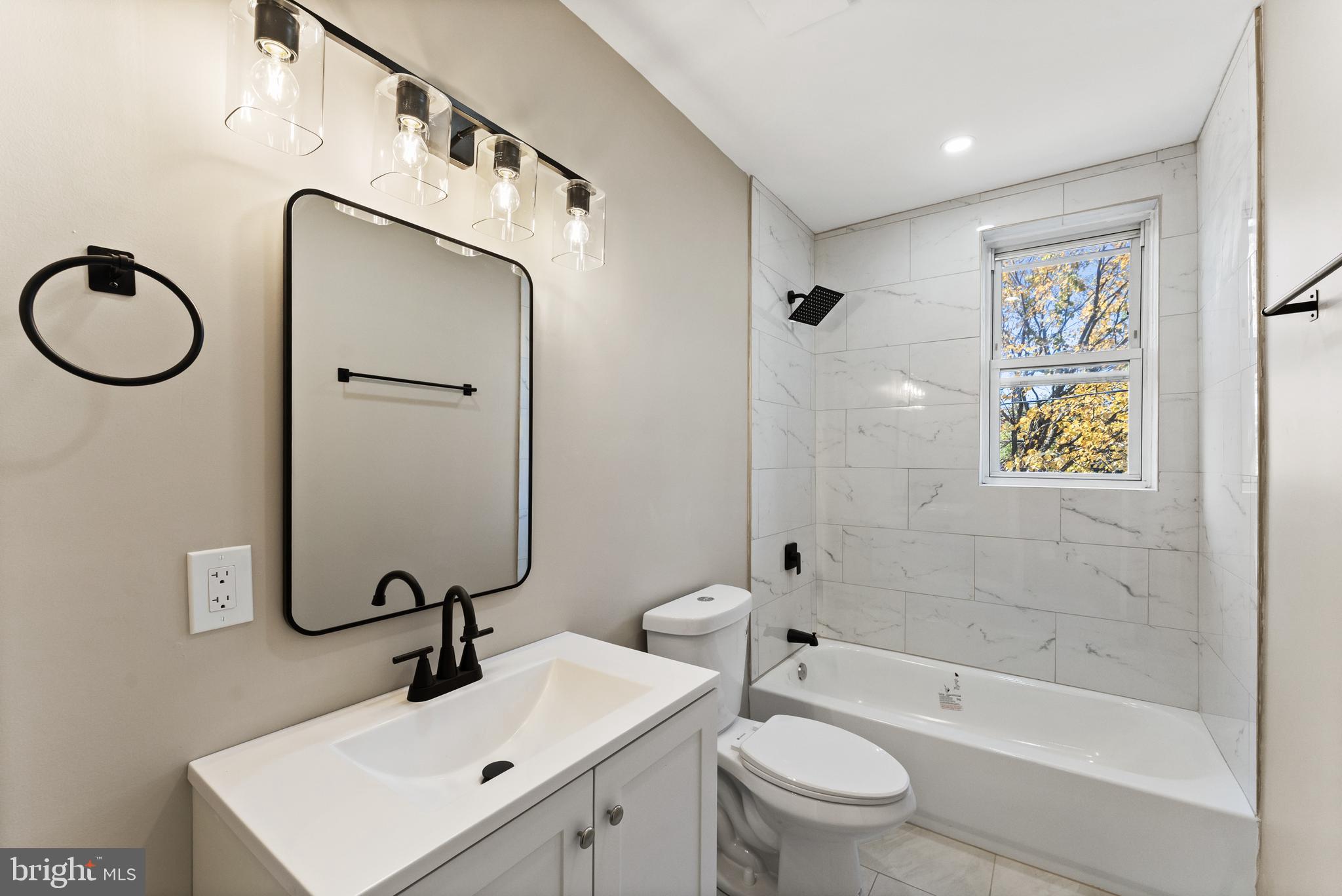 602 Denison Street Baltimore, MD 21229 - Photo 7 of 17 a bathroom with a sink a toilet and shower