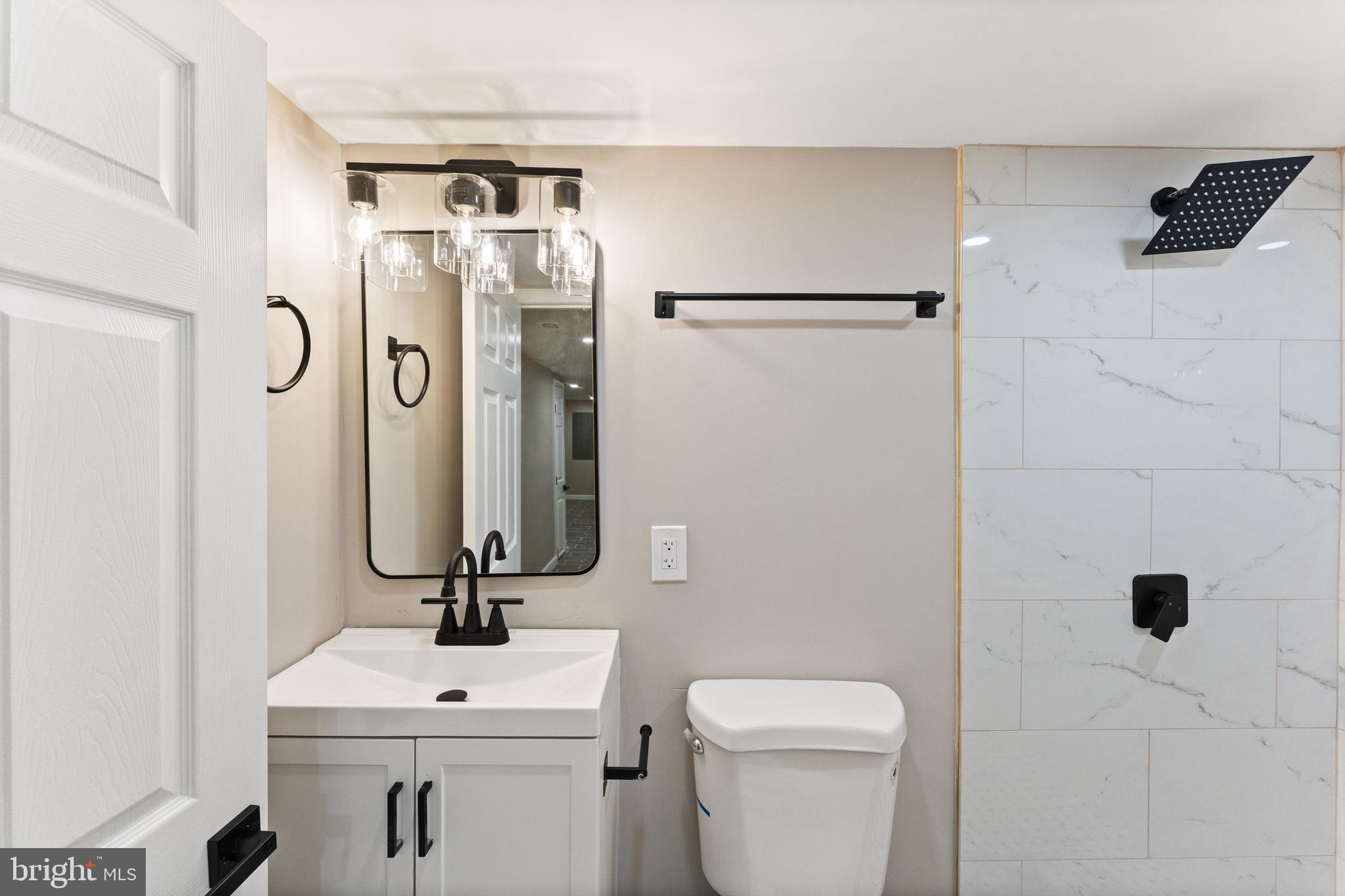 602 Denison Street Baltimore, MD 21229 - Photo 8 of 17 a bathroom with a sink toilet and shower