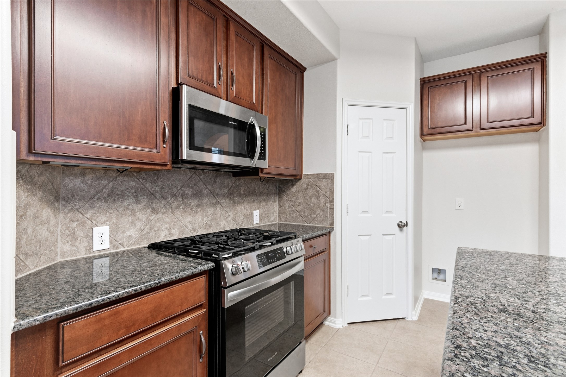 6211 Stone Hill Road Spring, TX 77389 - Photo 13 of 43 a kitchen with granite countertop stainless steel appliances and cabinets