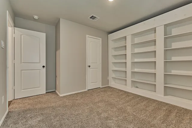 a view of an empty room and a window