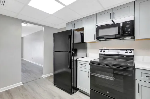 a kitchen with a refrigerator stove and microwave