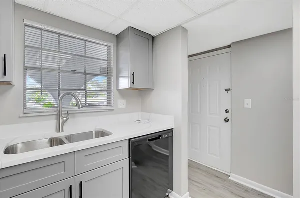 a kitchen with a sink and cabinets