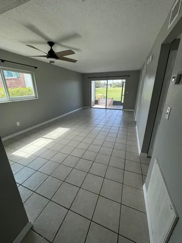 a view of an empty room and a window