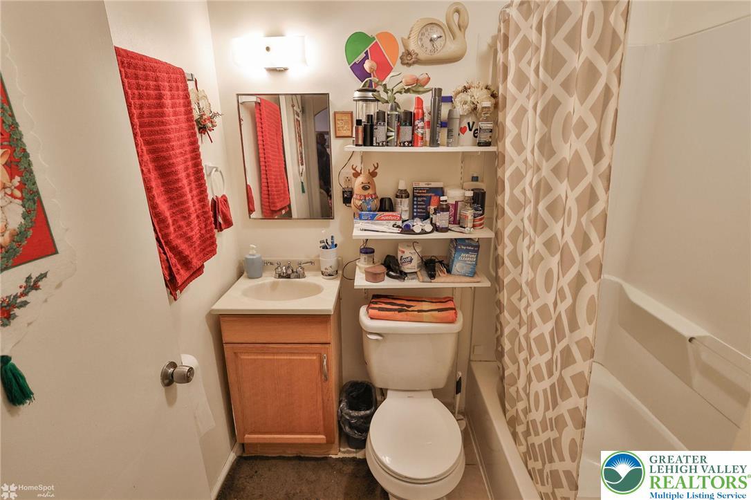 214 West Ridge Street Lansford, PA 18232 - Photo 15 of 52 a bathroom with a toilet and a shower curtain