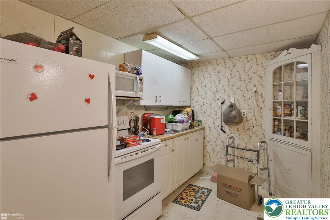 214 West Ridge Street Lansford, PA 18232 - Photo 23 of 52 a white refrigerator freezer sitting inside of a kitchen