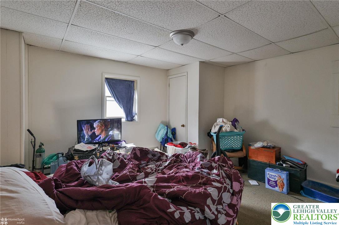 214 West Ridge Street Lansford, PA 18232 - Photo 26 of 52 a bed room with bed and a lamp