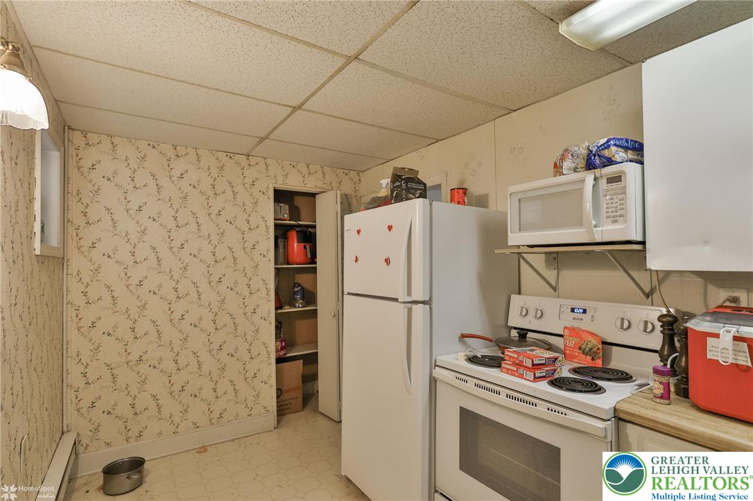 214 West Ridge Street Lansford, PA 18232 - Photo 31 of 52 a white refrigerator freezer and a stove sitting inside of a kitchen