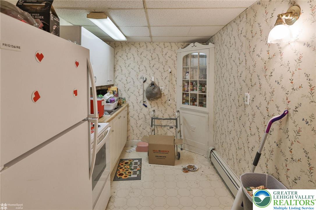 214 West Ridge Street Lansford, PA 18232 - Photo 38 of 52 a white refrigerator freezer sitting inside of a kitchen