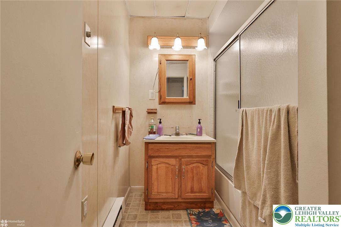 214 West Ridge Street Lansford, PA 18232 - Photo 41 of 52 a bathroom with a sink a mirror and a shower