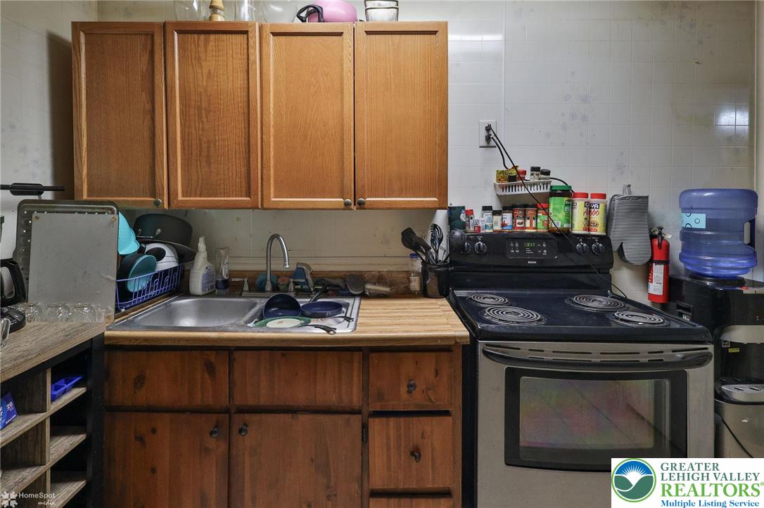 214 West Ridge Street Lansford, PA 18232 - Photo 45 of 52 a kitchen with a sink stove and cabinets