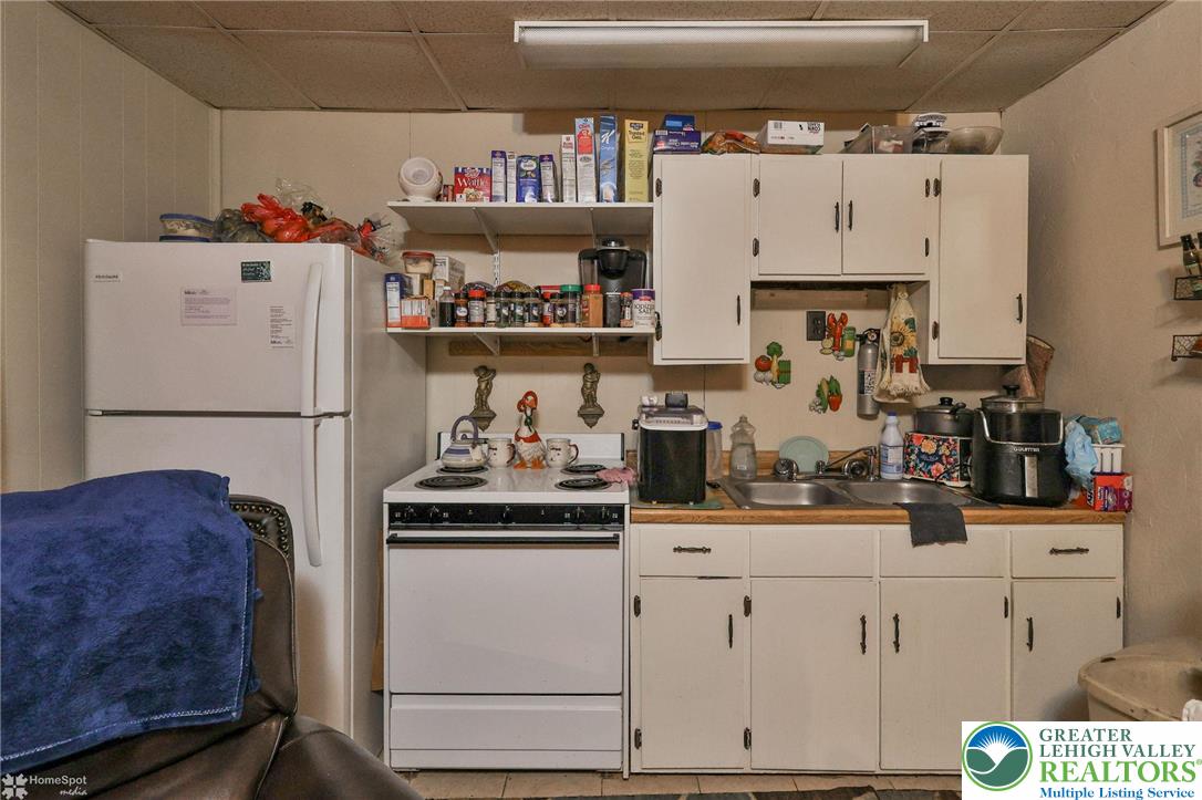 214 West Ridge Street Lansford, PA 18232 - Photo 7 of 52 a kitchen with refrigerator and cabinets