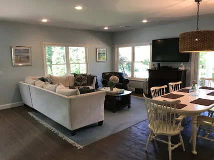 a living room with furniture a window and a fireplace