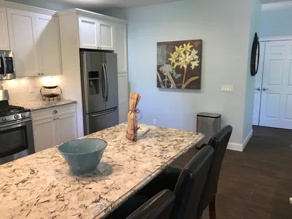 a kitchen with a stove a refrigerator and a dining table