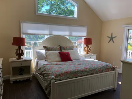 a bed sitting in a bedroom next to a window