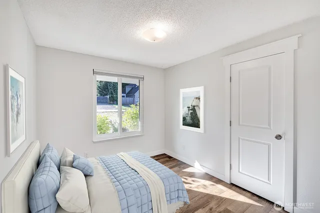 a bedroom with a bed and a window