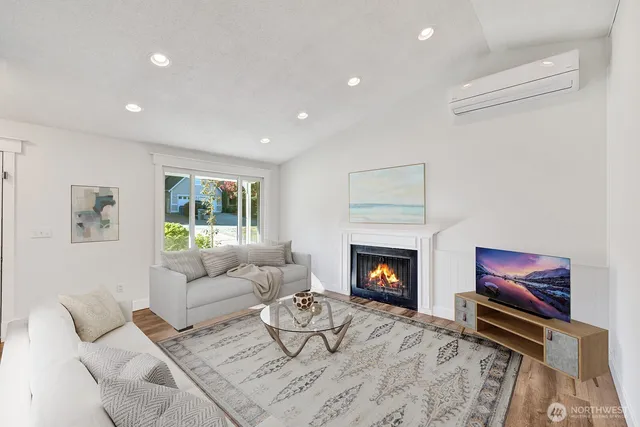 a living room with furniture a fireplace and a flat screen tv