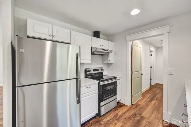 a kitchen with stainless steel appliances and refrigerator