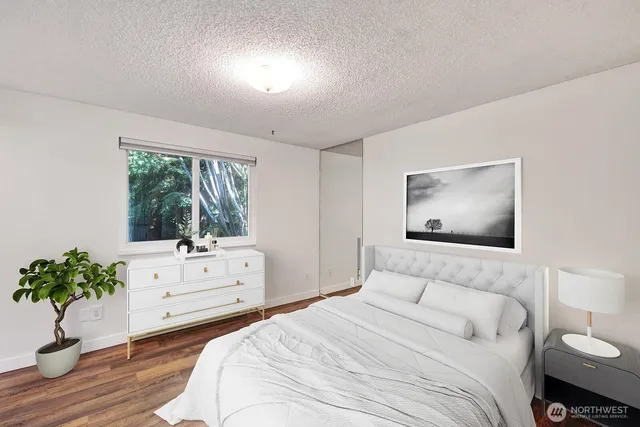 a bedroom with a bed and a potted plant