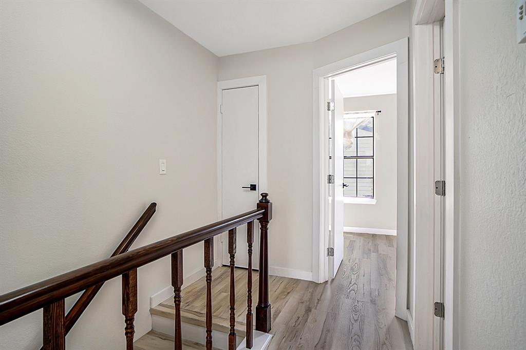 618 West Collins Street Denton, TX 76201 - Photo 16 of 25 Hall featuring light wood-style floors and an upstairs landing
